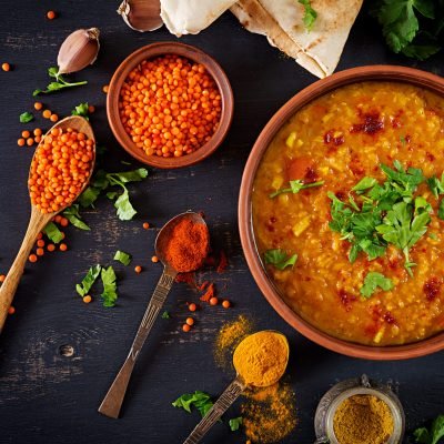 traditional-indian-soup-lentils-indian-dhal-spicy-curry-bowl-spices-herbs-rustic-black-wooden-table Indian dal. Food. Traditional Indian soup lentils. Indian Dhal spicy curry in bowl, spices, herbs, rustic black wooden background. Top view. Authentic Indian dish. Overhead. Flat lay